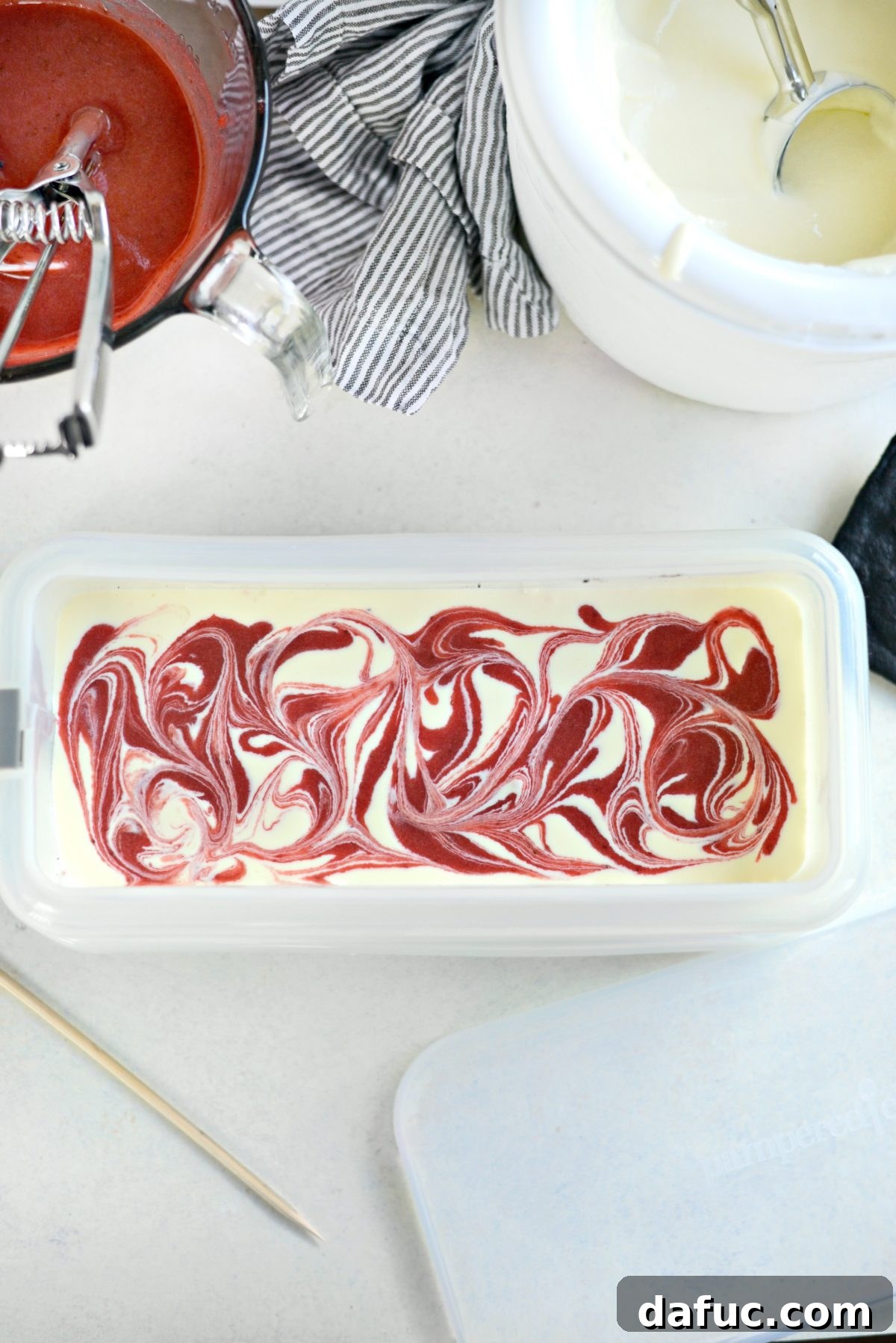 Swirling strawberry puree into ice cream