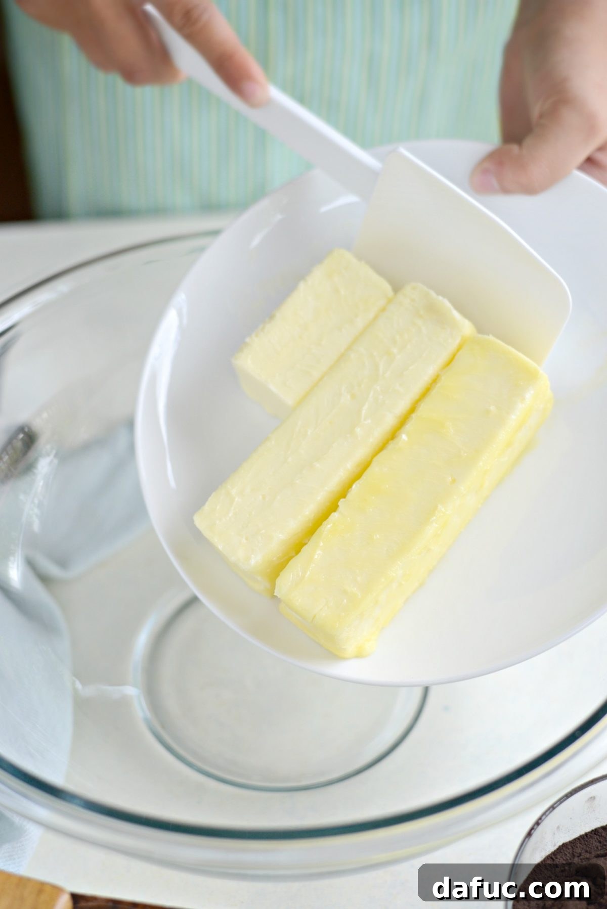 Adding butter to a bowl for chocolate cookies