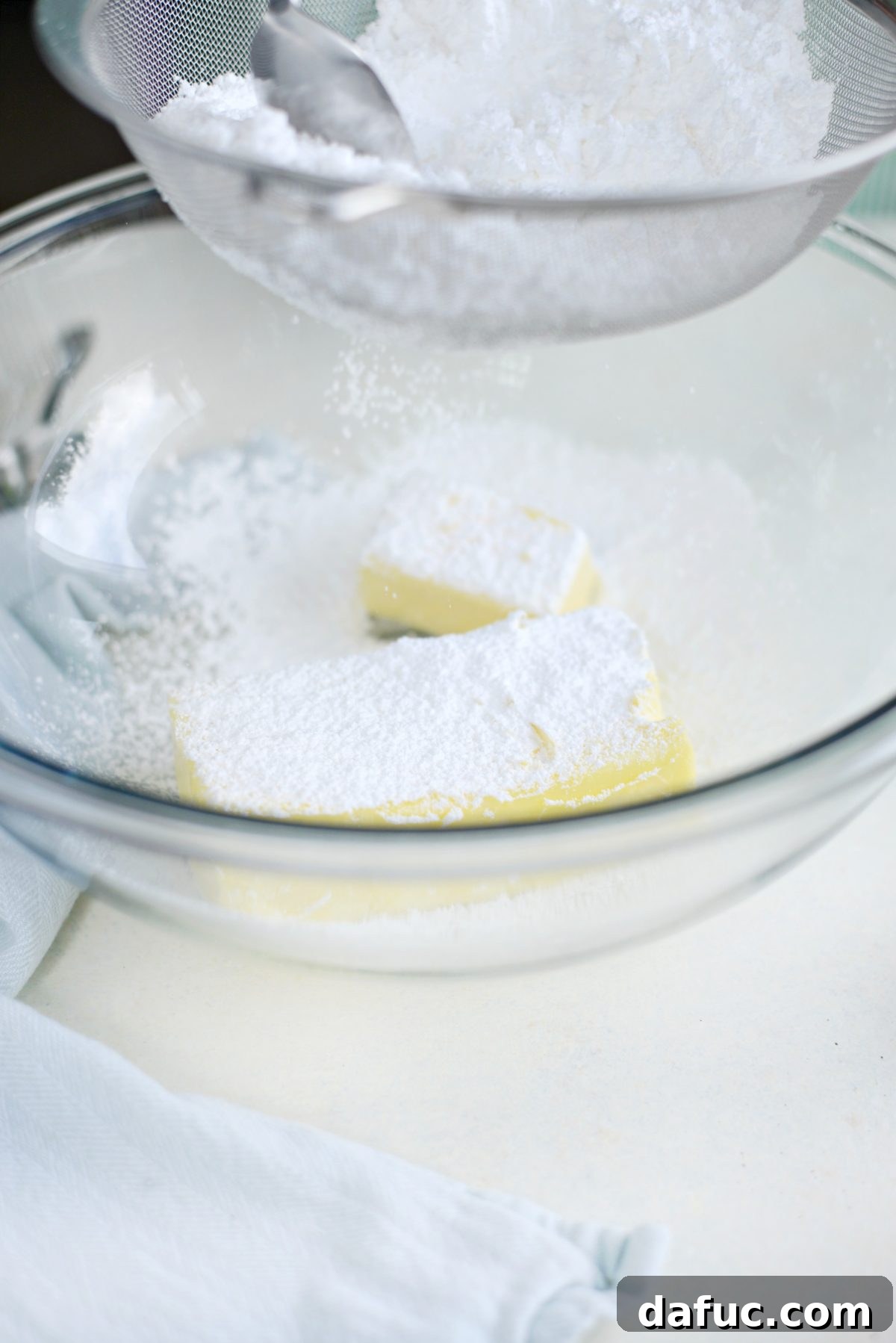 Sifting powdered sugar for the cookies