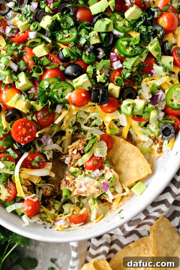 Fiesta Seven Layer Taco Dip 17 Seven Layer Taco Dip with a Scoop Taken Out