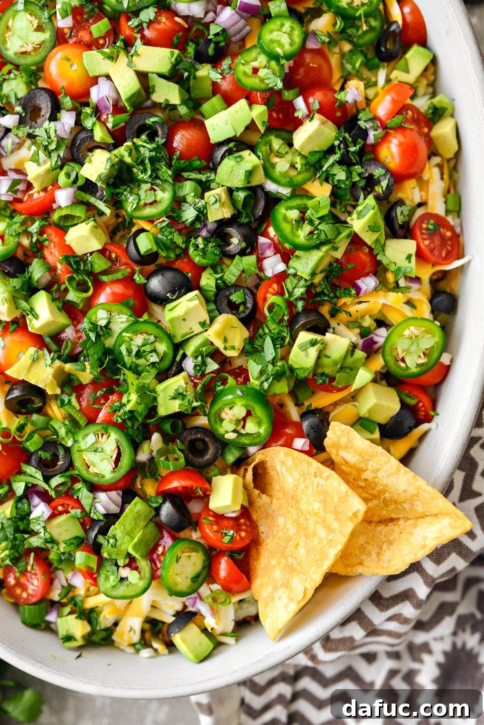 Fiesta Seven Layer Taco Dip 3 Close-up of 7-Layer Taco Dip with Crispy Tortilla Chips