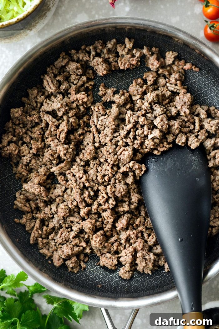 Fiesta Seven Layer Taco Dip 6 Cooked and Drained Ground Beef in Skillet