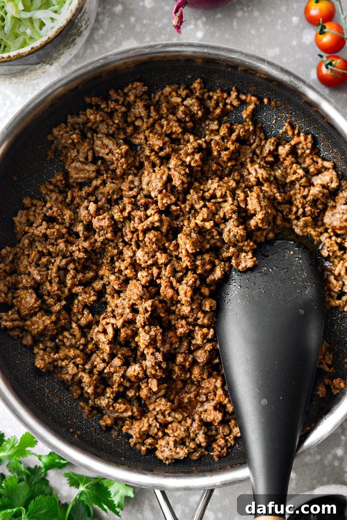 Fiesta Seven Layer Taco Dip 8 Stirring Taco Seasoning into Ground Beef