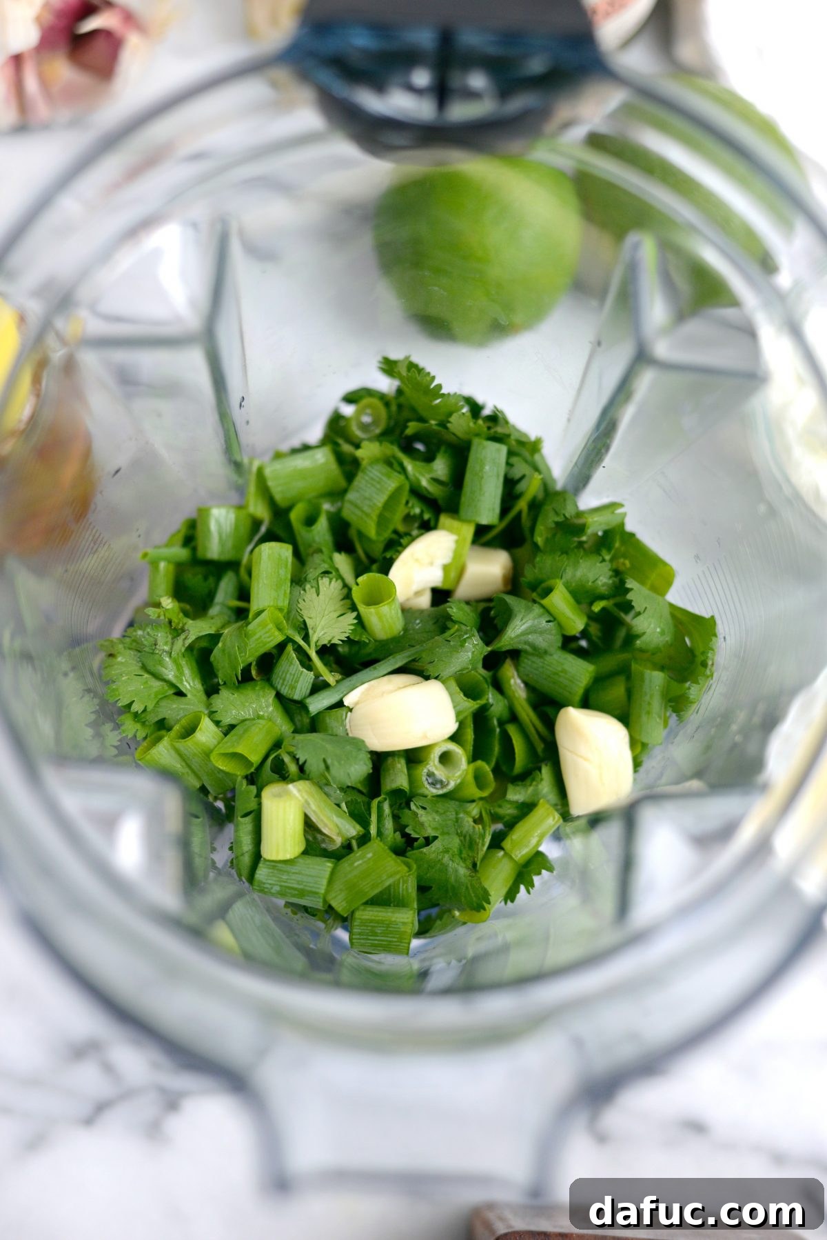 Adding ingredients to a blender for cilantro lime dressing