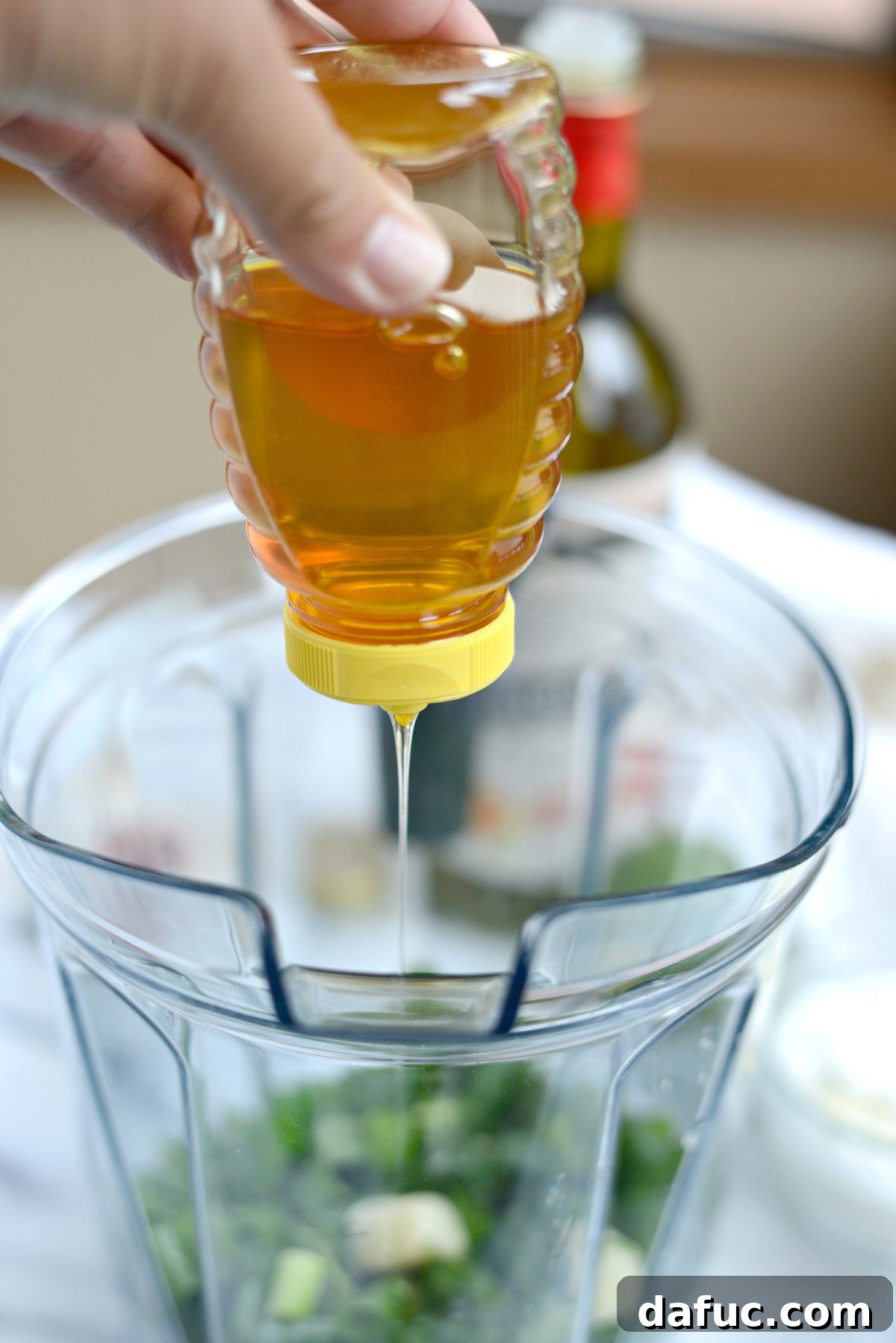Squeezing honey into the dressing