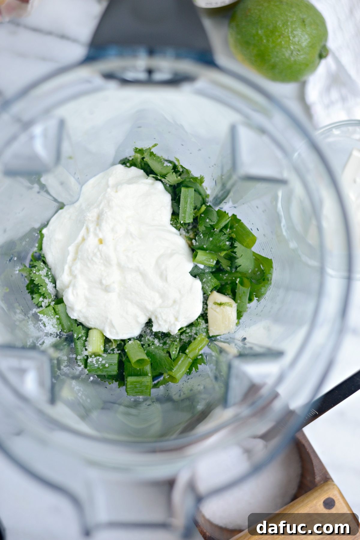 Seasoning and adding Greek yogurt to the blender