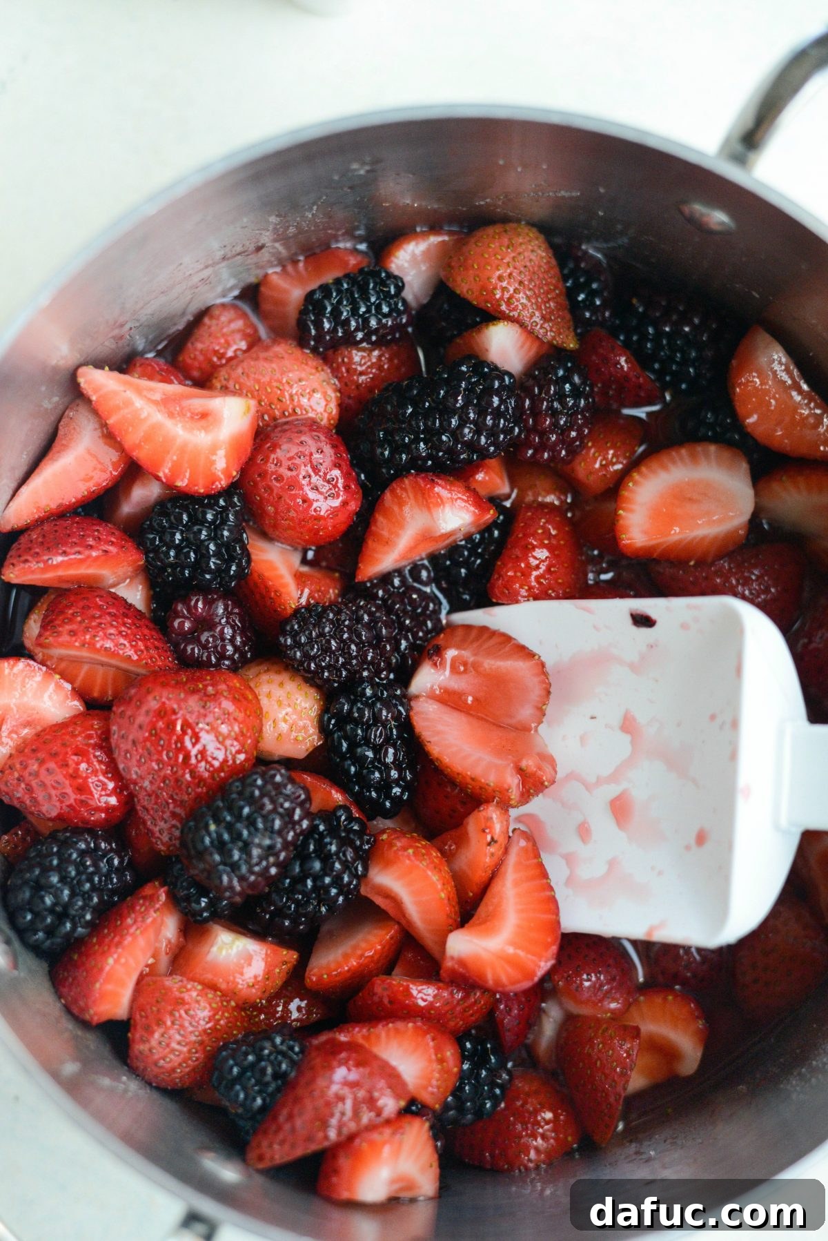 Close-up of berries simmering in a saucepan.