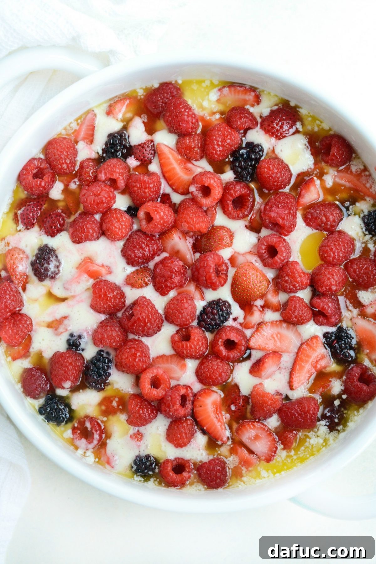 Cobbler assembled with berries on top, ready for baking.