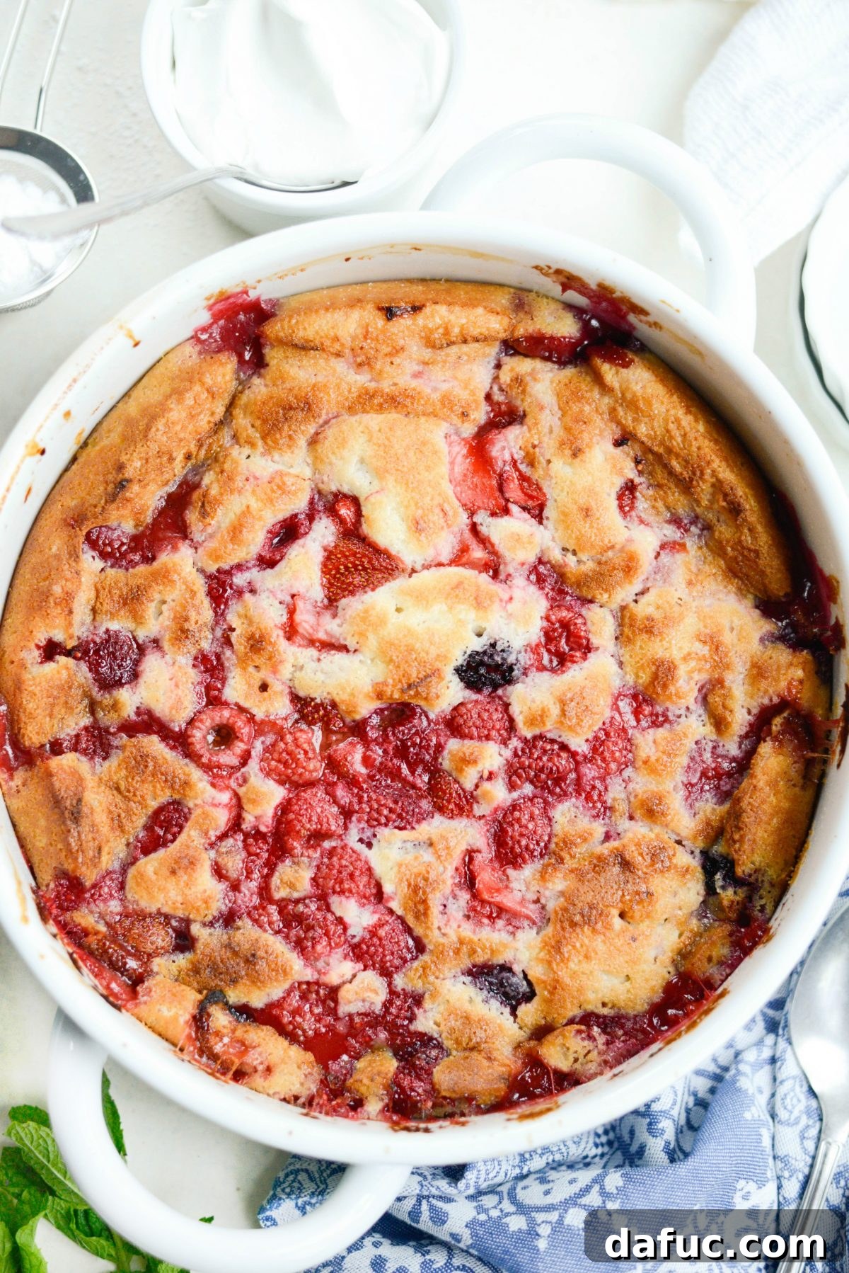 Freshly baked Triple Berry Cobbler, golden brown and bubbly.
