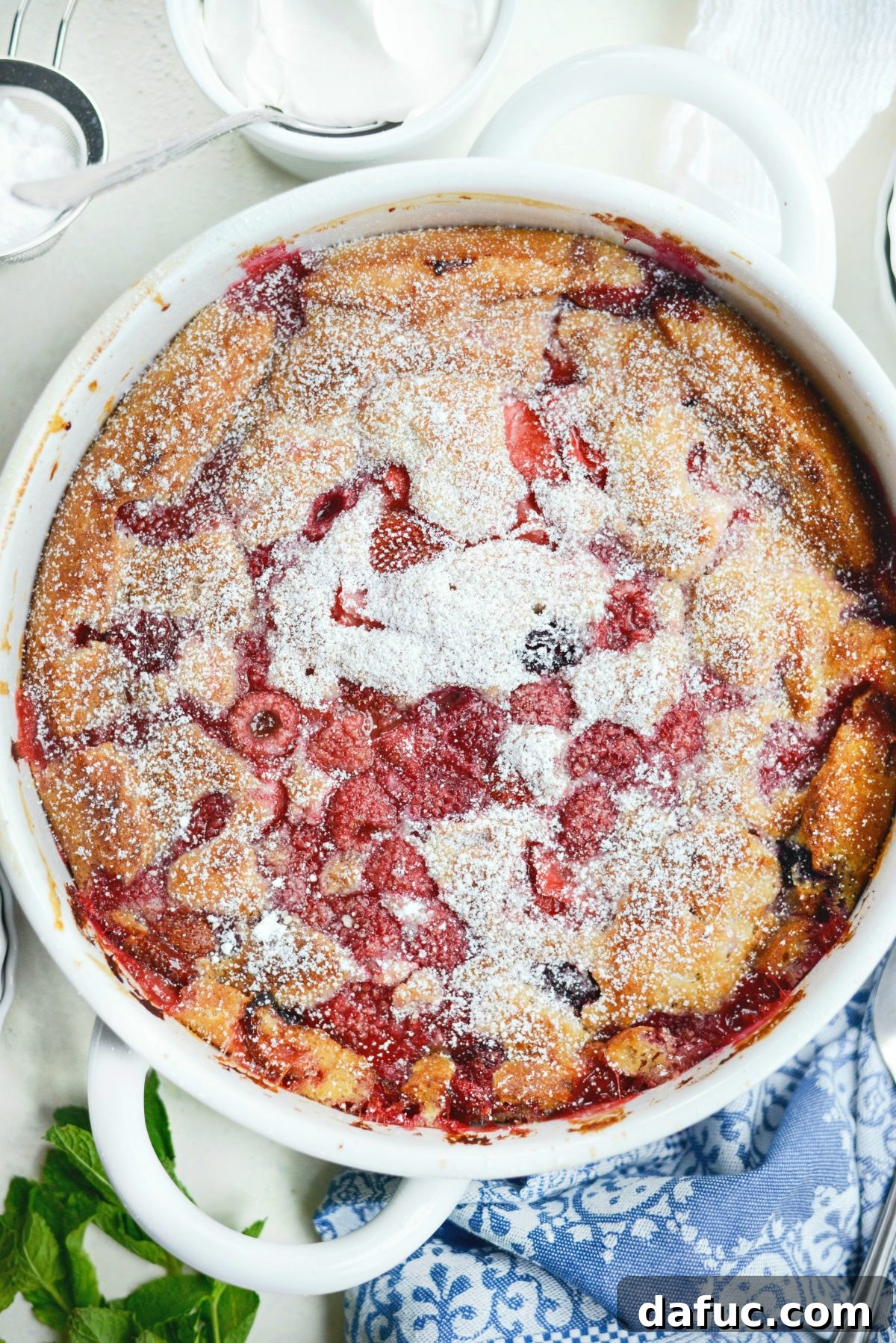 Served Triple Berry Cobbler in a shallow dish with ice cream.