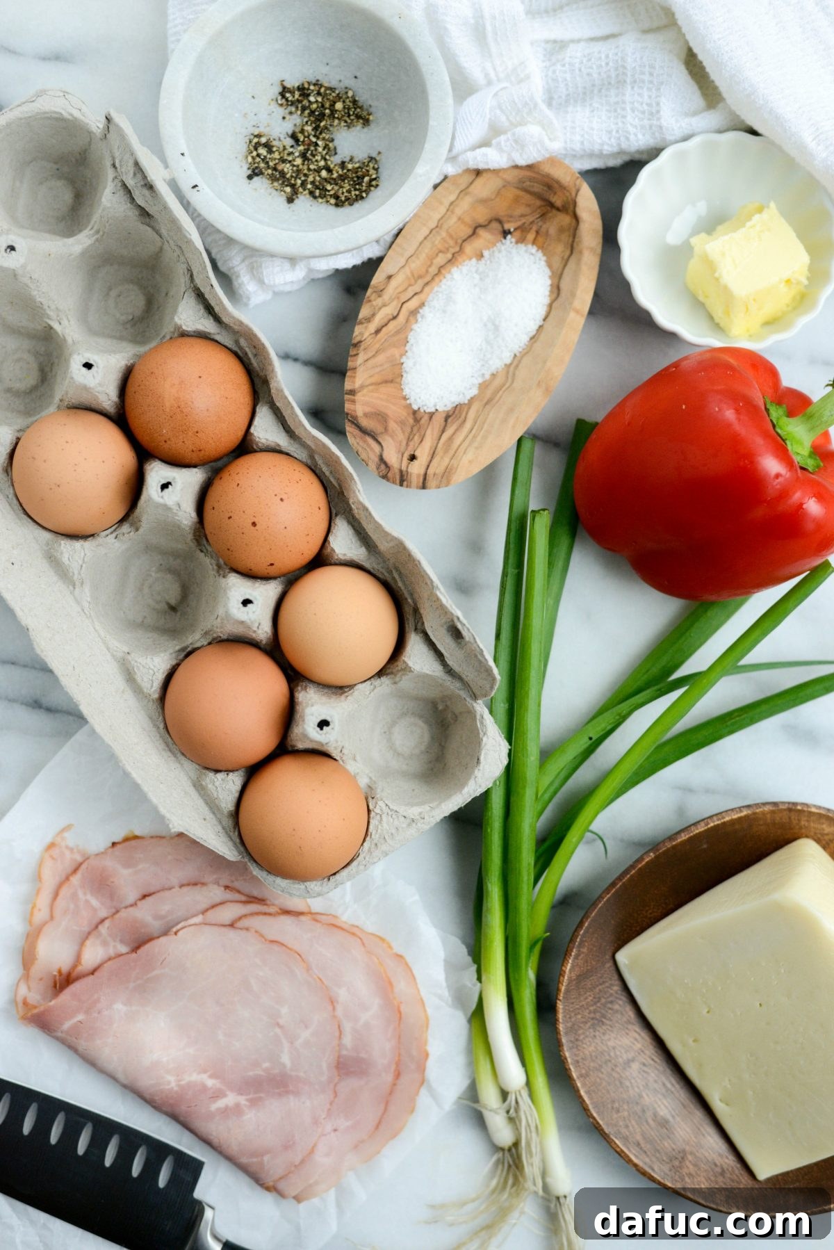 Cowboy Breakfast Frittata 3 Fresh ingredients laid out for Western Frittata preparation, including eggs, ham, bell peppers, and Swiss cheese