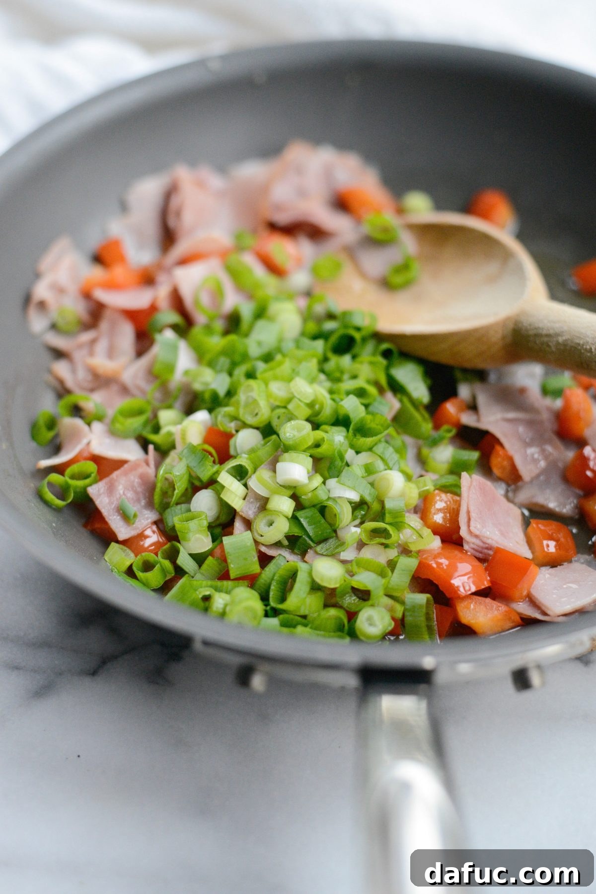 Cowboy Breakfast Frittata 6 Diced bell peppers, ham, and green onions sautéing in a non-stick skillet