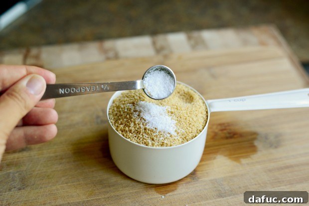 Mastering Fluffy Couscous in Minutes 6 Lidded saucepan boiling water and olive oil for couscous