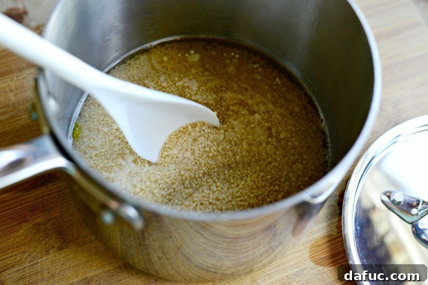 Mastering Fluffy Couscous in Minutes 8 Adding couscous and salt to boiling water and oil