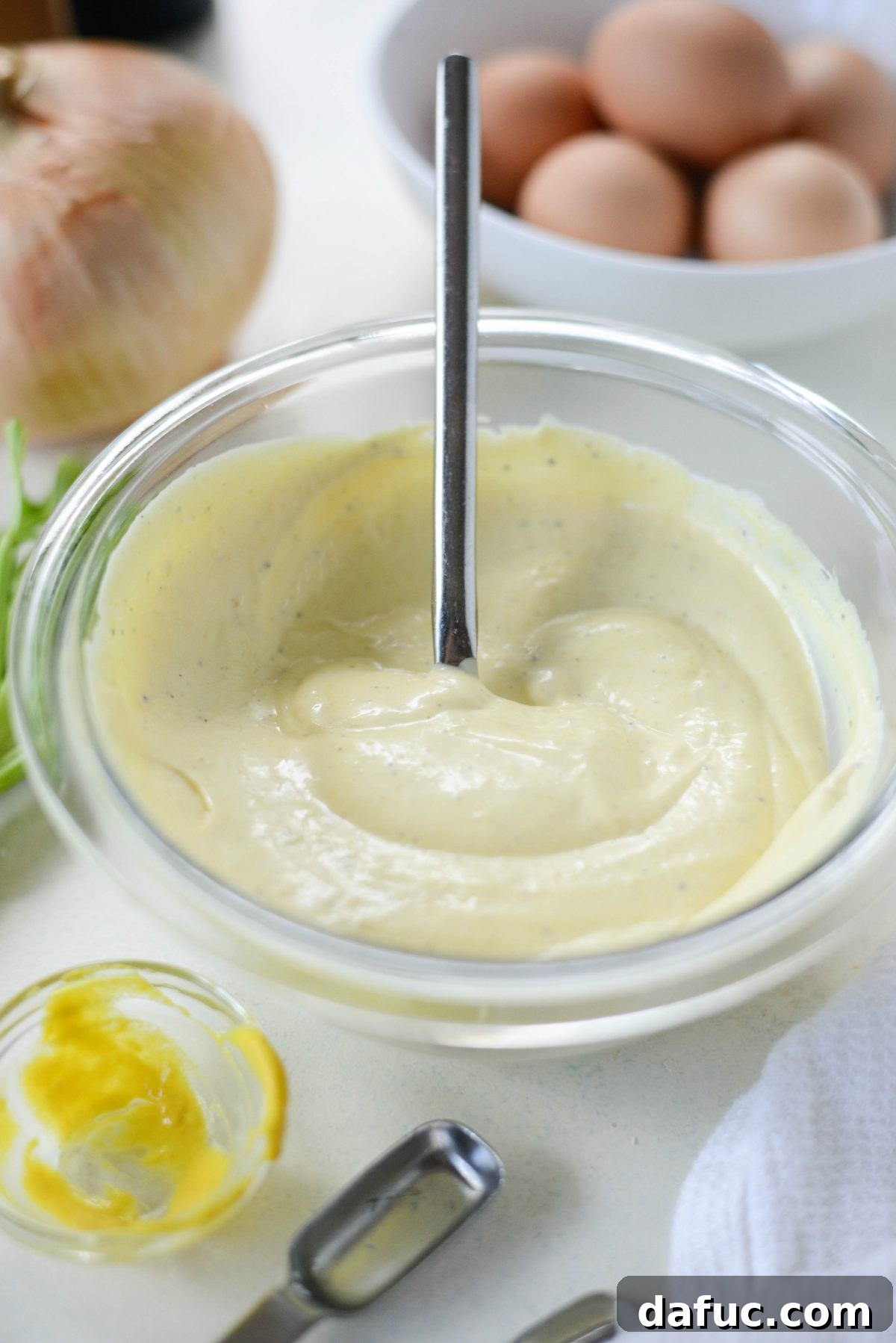 Creamy potato salad dressing in a bowl, stirred and ready for chilling.