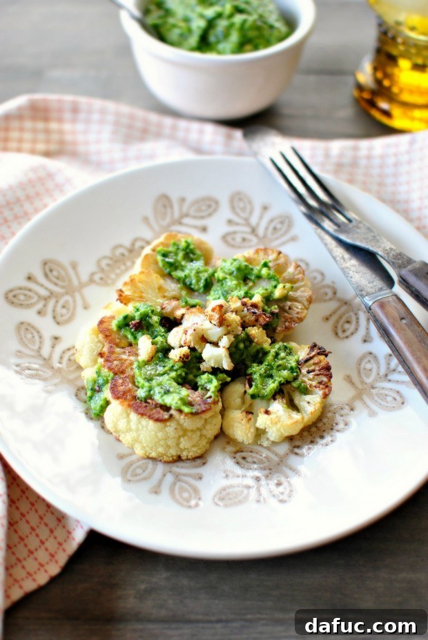 Roasted Cauliflower Steaks with Toasted Walnut Parsley Pesto, a gourmet vegetarian dish
