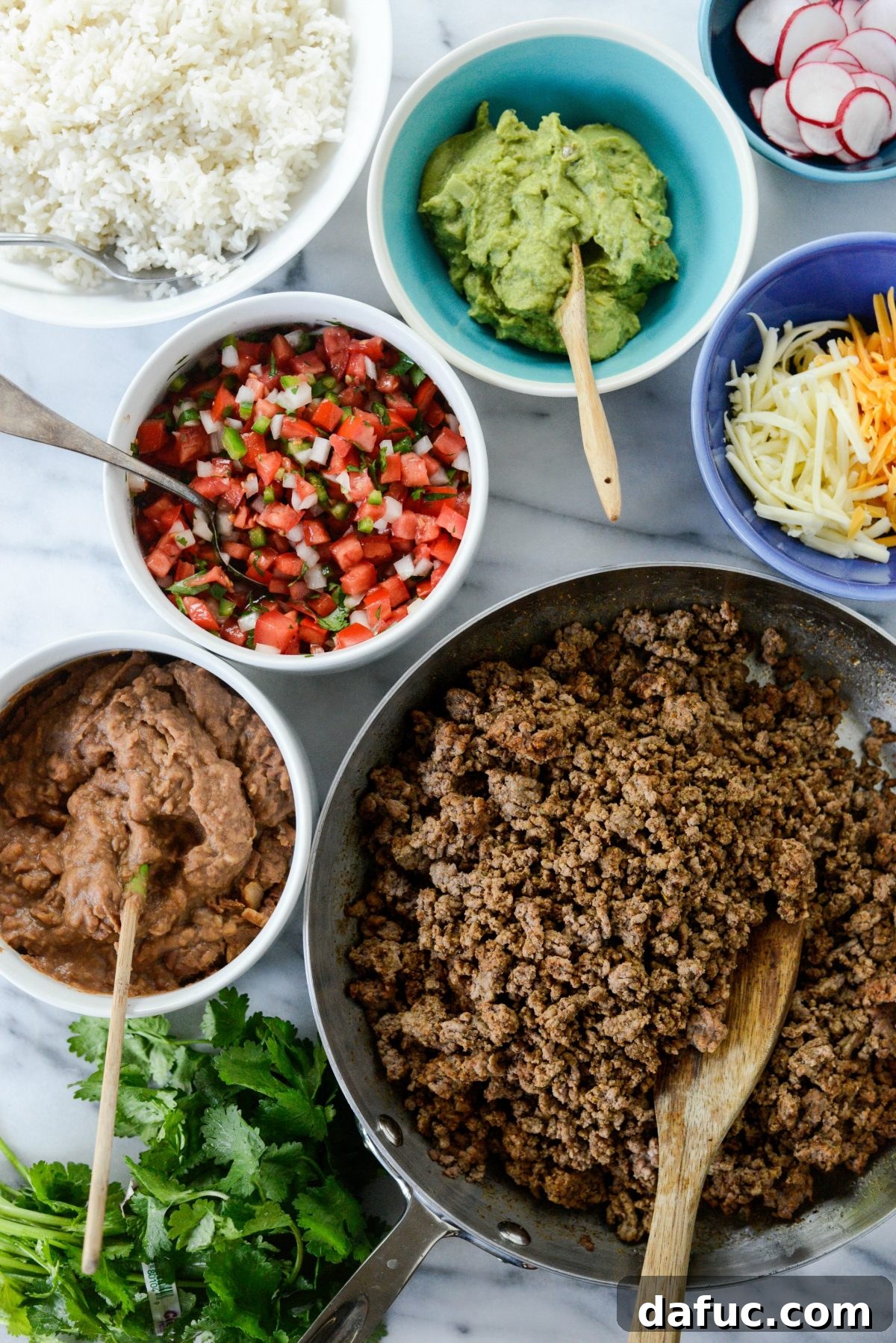 Beefy Bean Burrito Bowls 3 Close-up of a vibrant Cheesy Beef and Bean Burrito Rice Bowl with fresh toppings