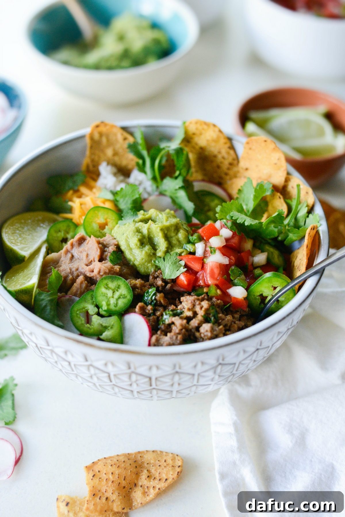 Beefy Bean Burrito Bowls 7 Close-up of crispy sweet potato tortilla chips accompanying the burrito bowl