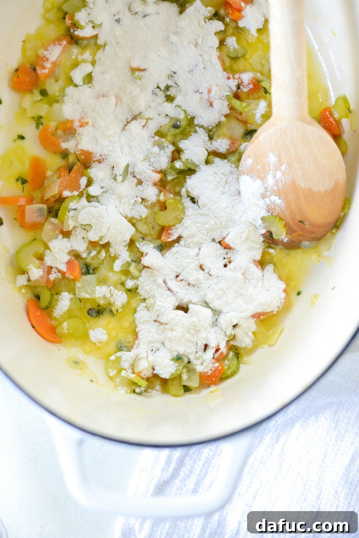 Sprinkling all-purpose flour into the cooked vegetables