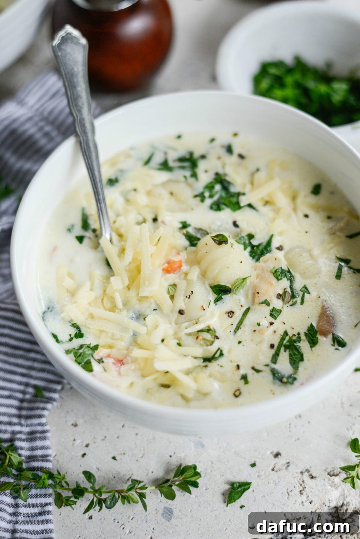 Close-up of Creamy Chicken Gnocchi Soup with fresh parsley garnish