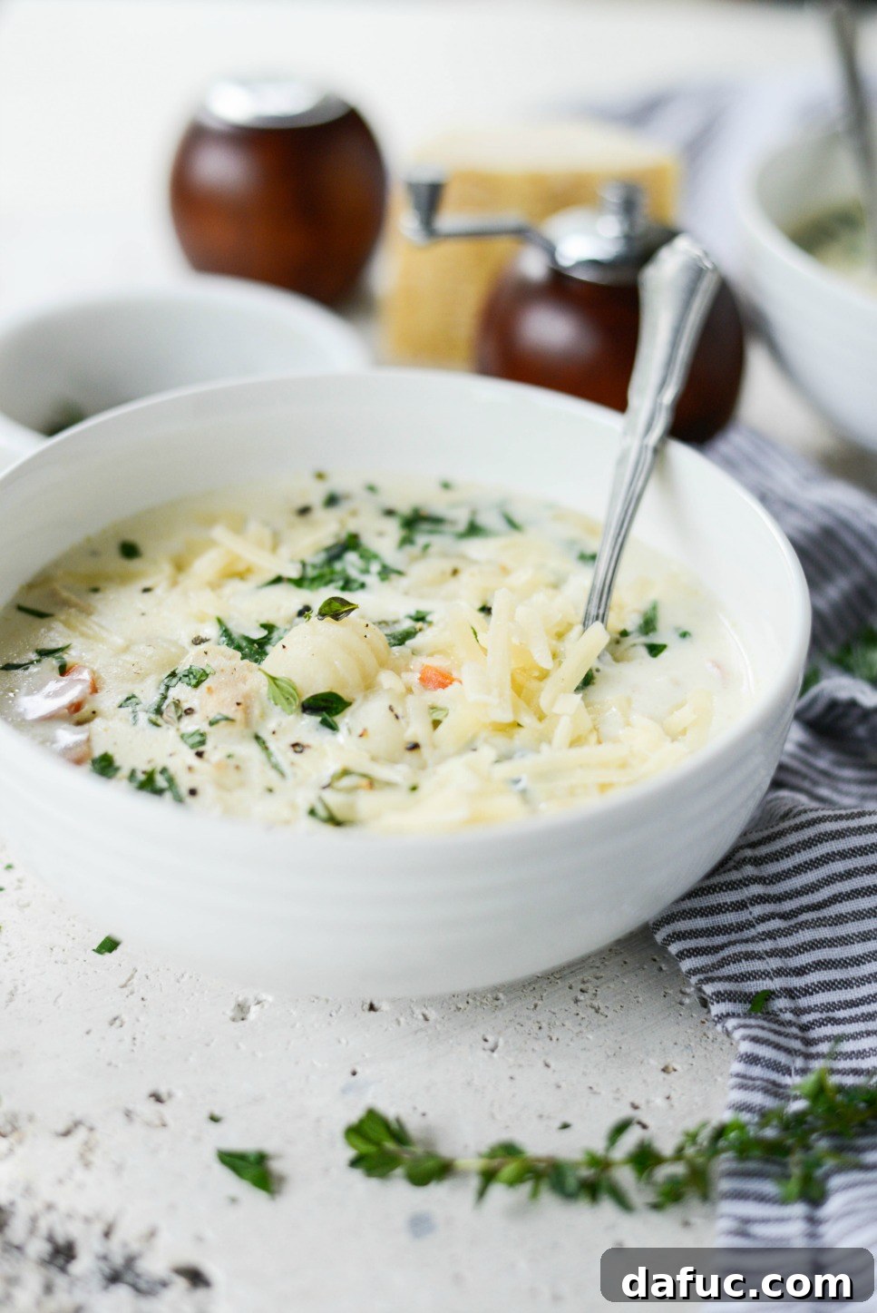 A top-down view of Creamy Chicken Gnocchi Soup in a rustic bowl