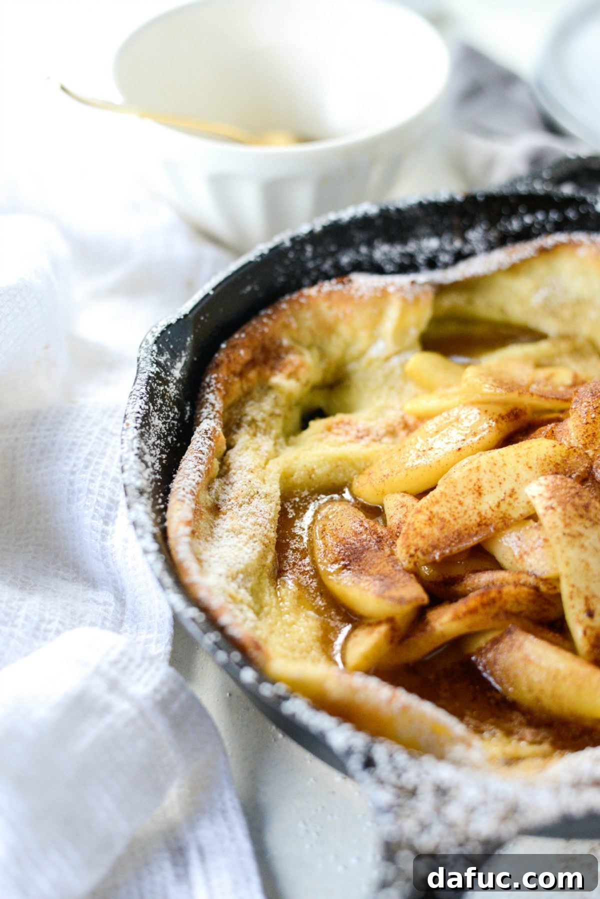 Sweet Caramel Apple Skillet Puff 12 Caramelized Apple Dutch Baby topped with apples, caramel drizzle, and cinnamon.