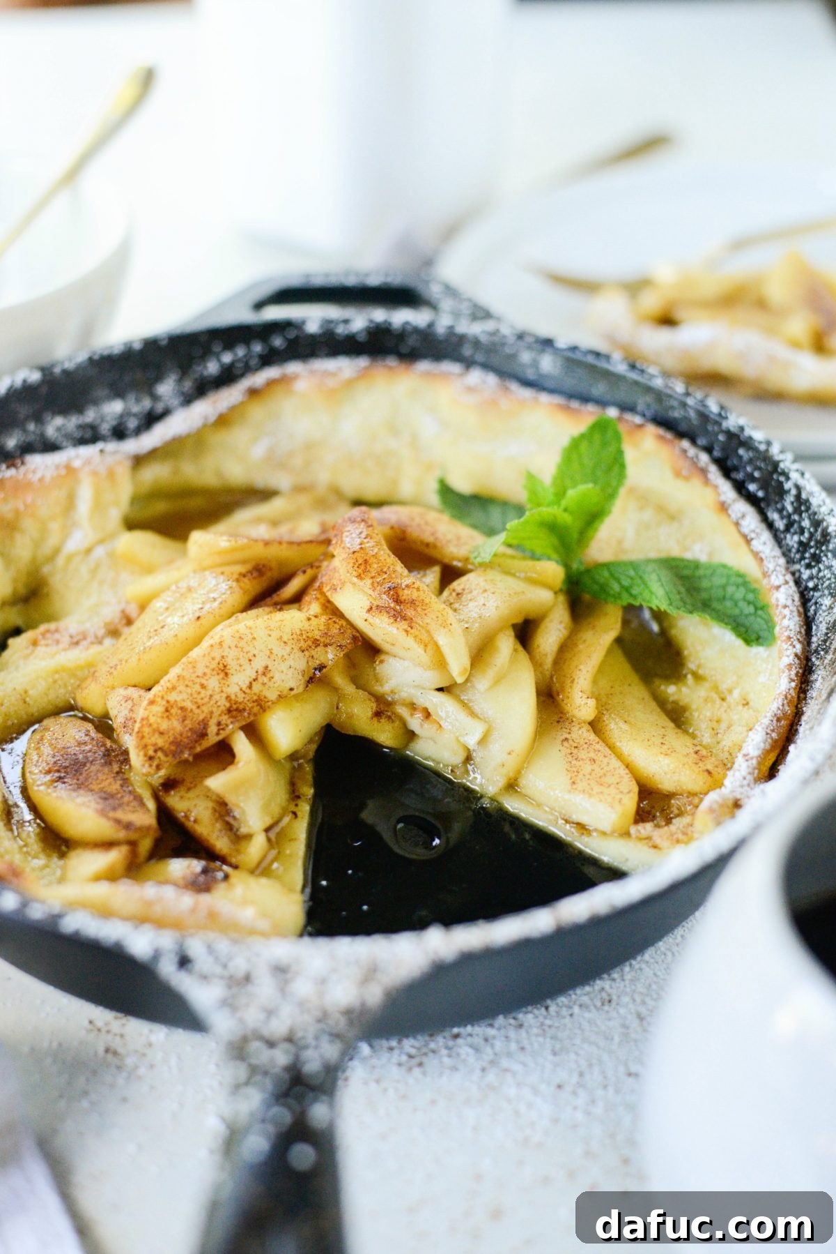 Sweet Caramel Apple Skillet Puff 3 An open copy of 'Cast Iron Gourmet' cookbook, with sticky notes marking favorite recipes.