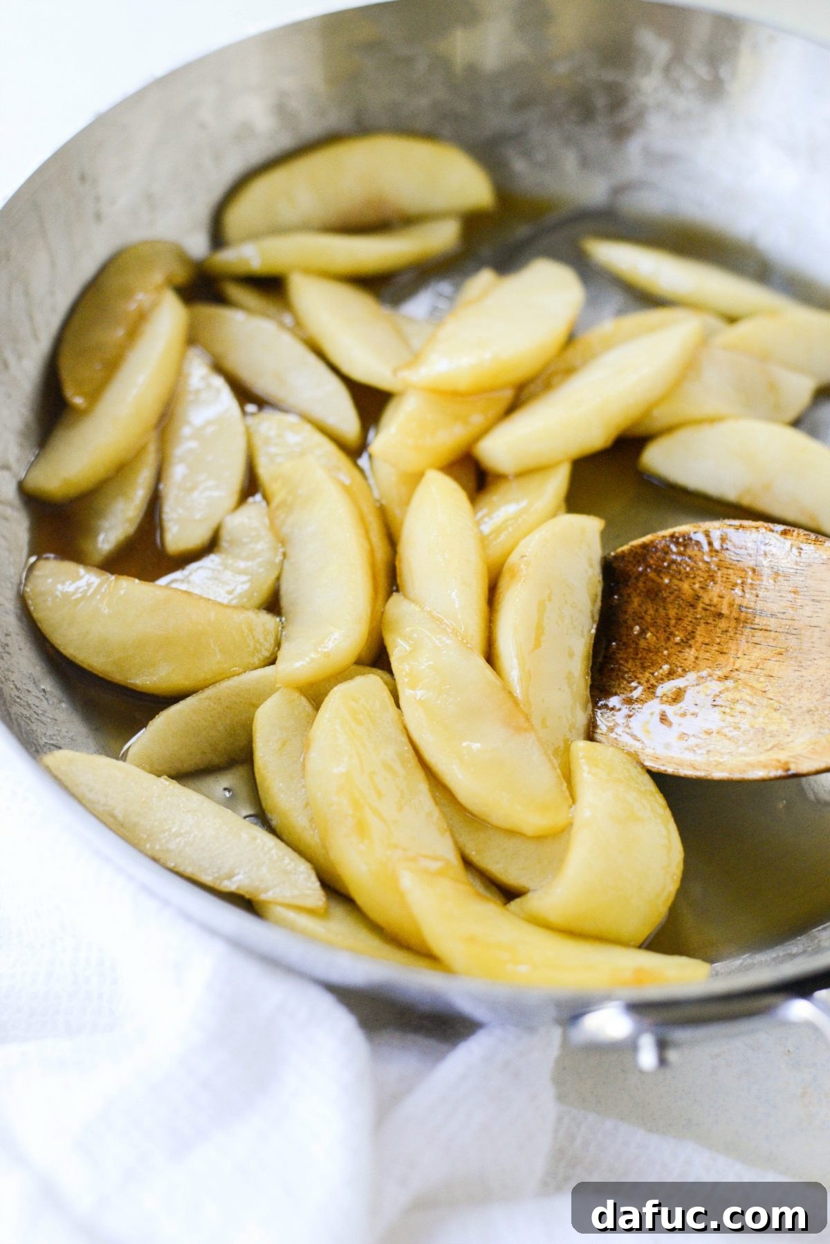 Sweet Caramel Apple Skillet Puff 7 Caramelized apple slices cooking in a skillet with brown sugar and butter.