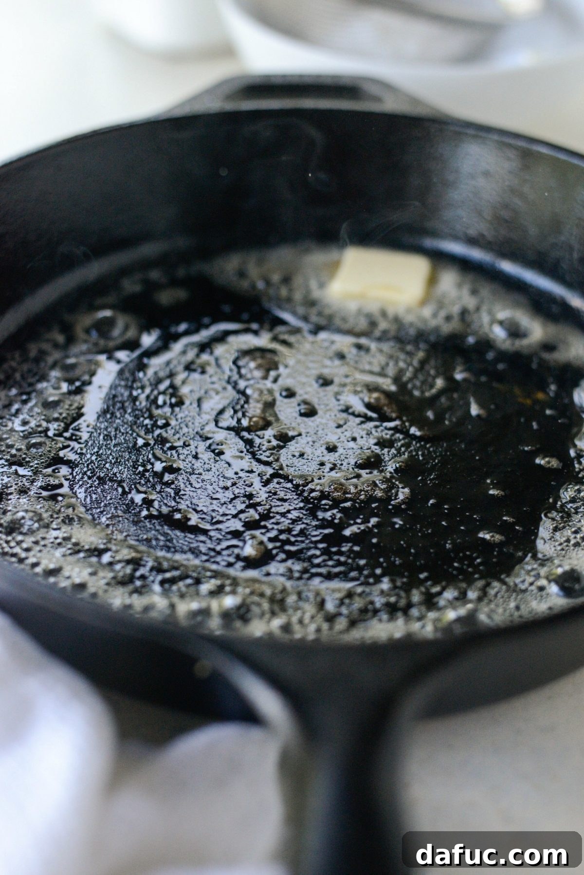 Sweet Caramel Apple Skillet Puff 8 Butter sizzling and bubbling in a hot cast iron skillet, ready for Dutch Baby batter.
