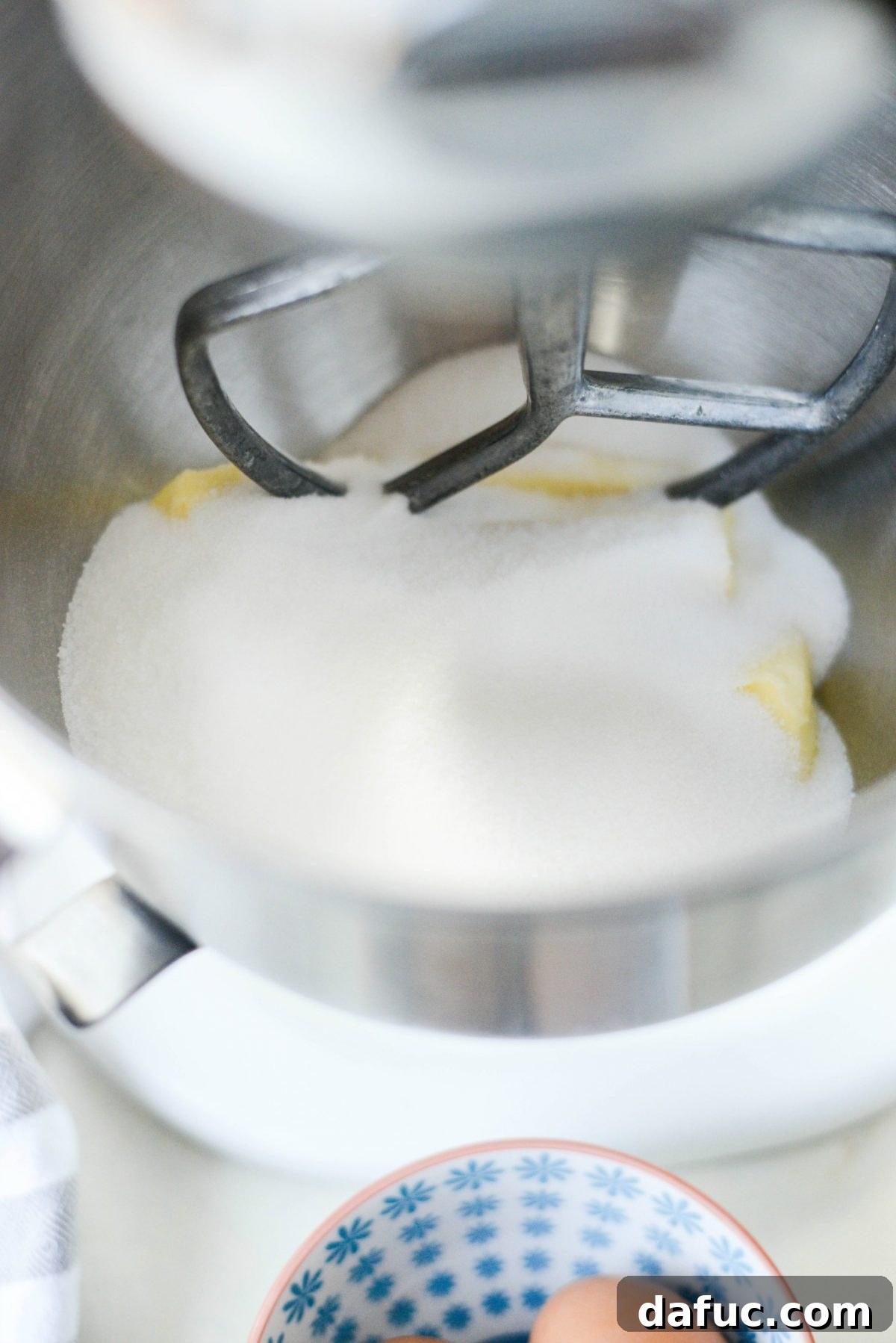 Golden Cinnamon Sugar Delights 5 Softened butter and granulated sugar being creamed together in the bowl of a stand mixer.