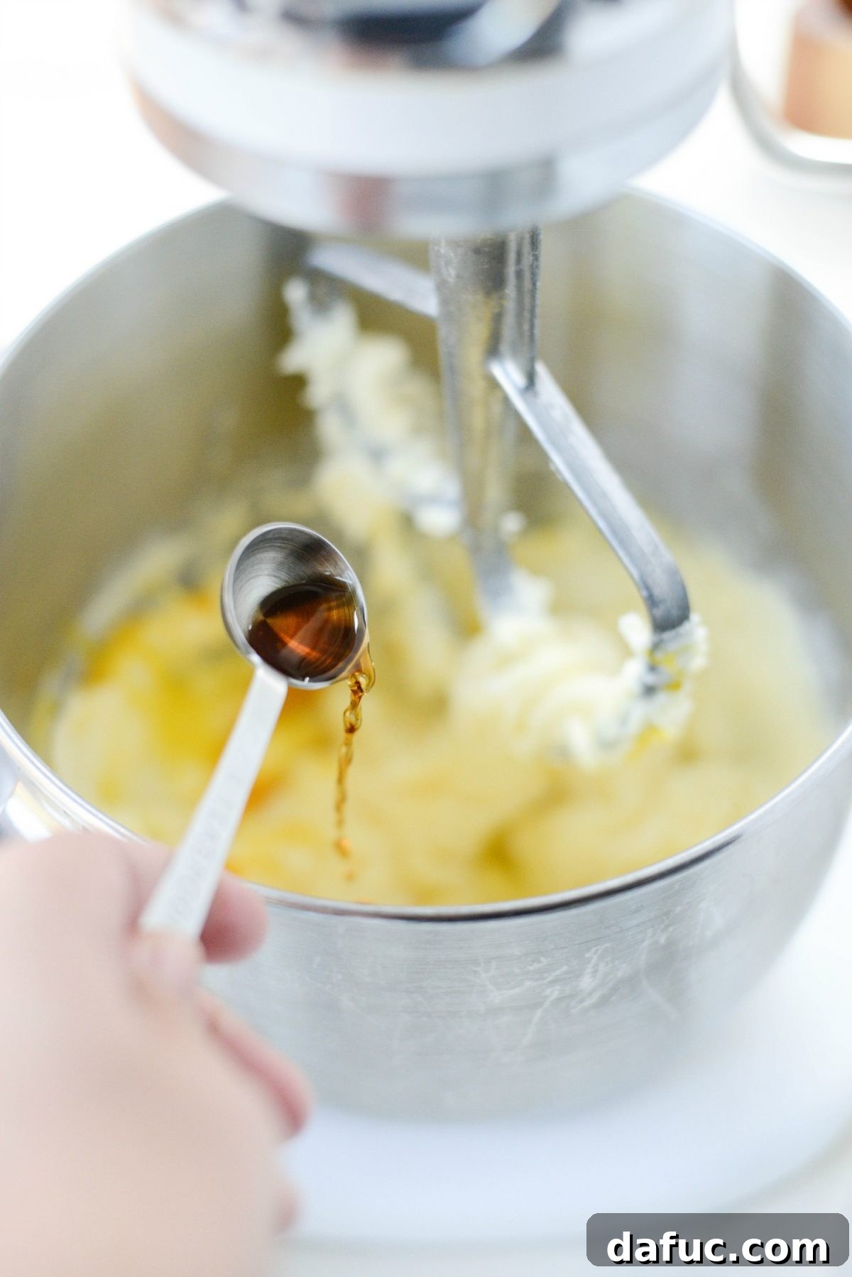 Golden Cinnamon Sugar Delights 8 Adding vanilla extract to the cookie dough mixture.
