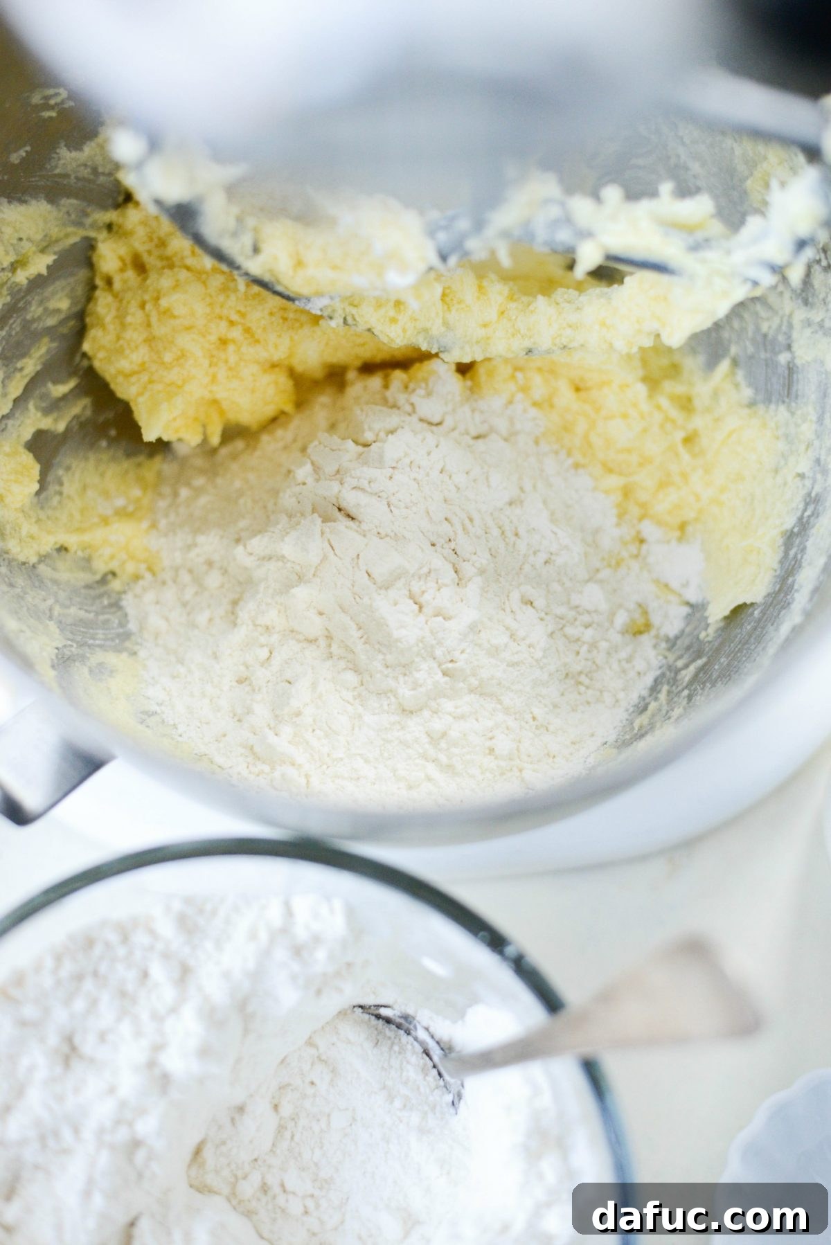Golden Cinnamon Sugar Delights 10 Gradually adding dry ingredients to the wet butter and sugar mixture in a stand mixer.