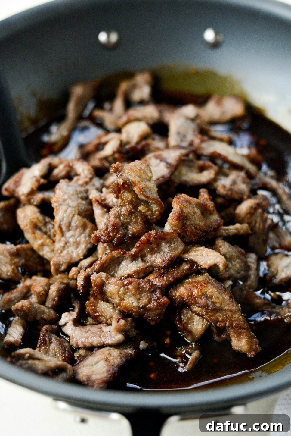 Speedy Sesame Mongolian Beef 13 Adding crispy fried beef back into the pan with the thickened sauce