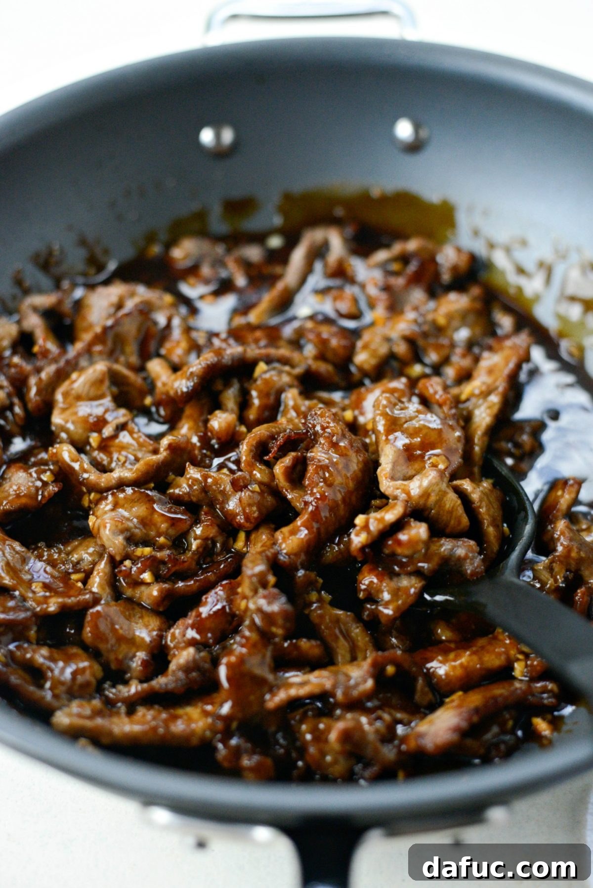 Speedy Sesame Mongolian Beef 14 Tossing the crispy beef in the Mongolian sauce