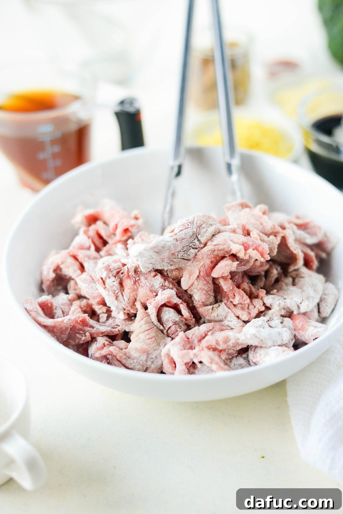 Speedy Sesame Mongolian Beef 6 Sliced beef coated in white pepper and cornstarch in a bowl