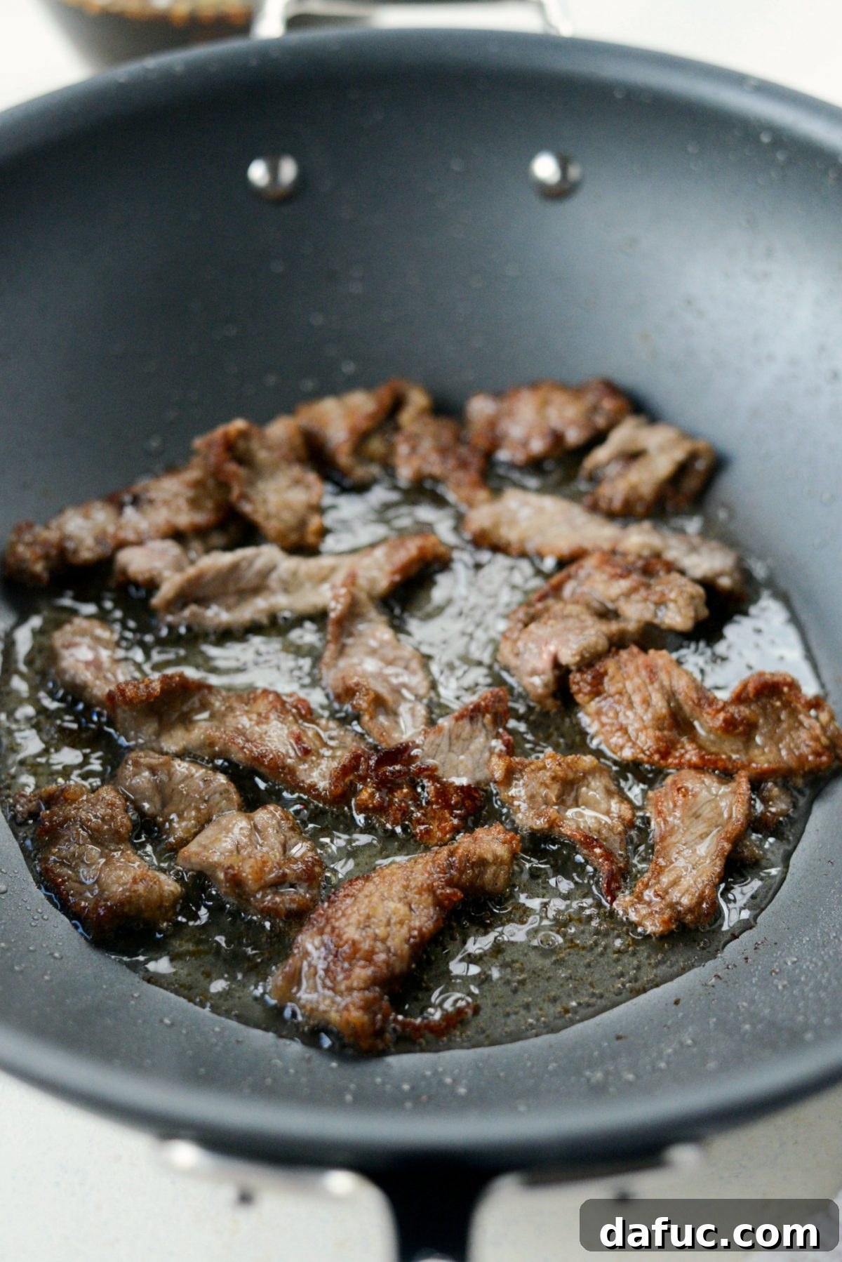 Restaurant-Style Weeknight Mongolian Beef 9 Crispy browned beef in pan.