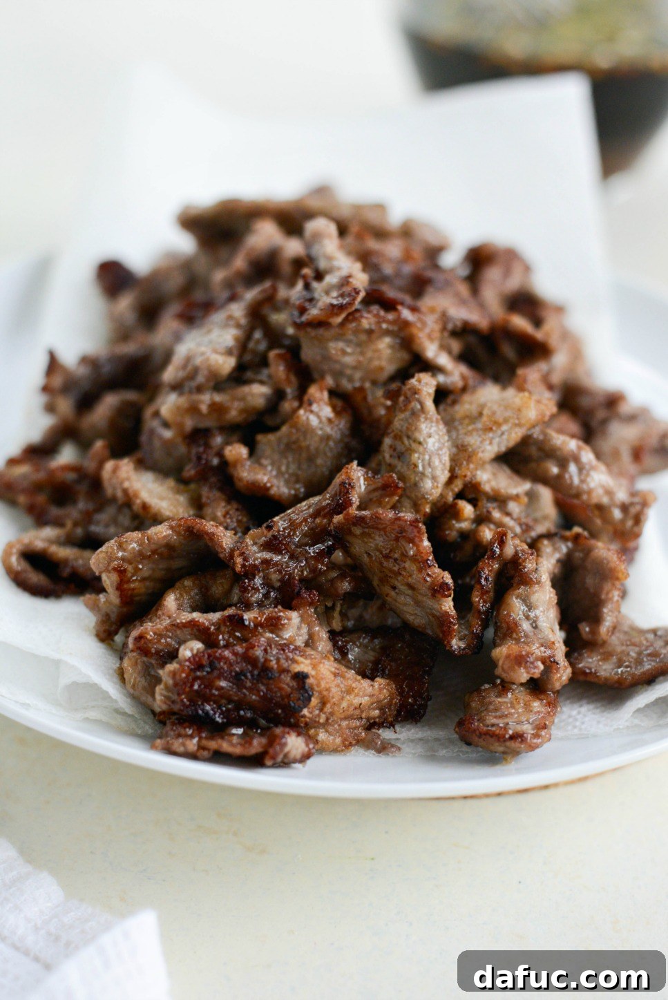 Speedy Sesame Mongolian Beef 10 Transferring cooked beef to a paper towel-lined plate