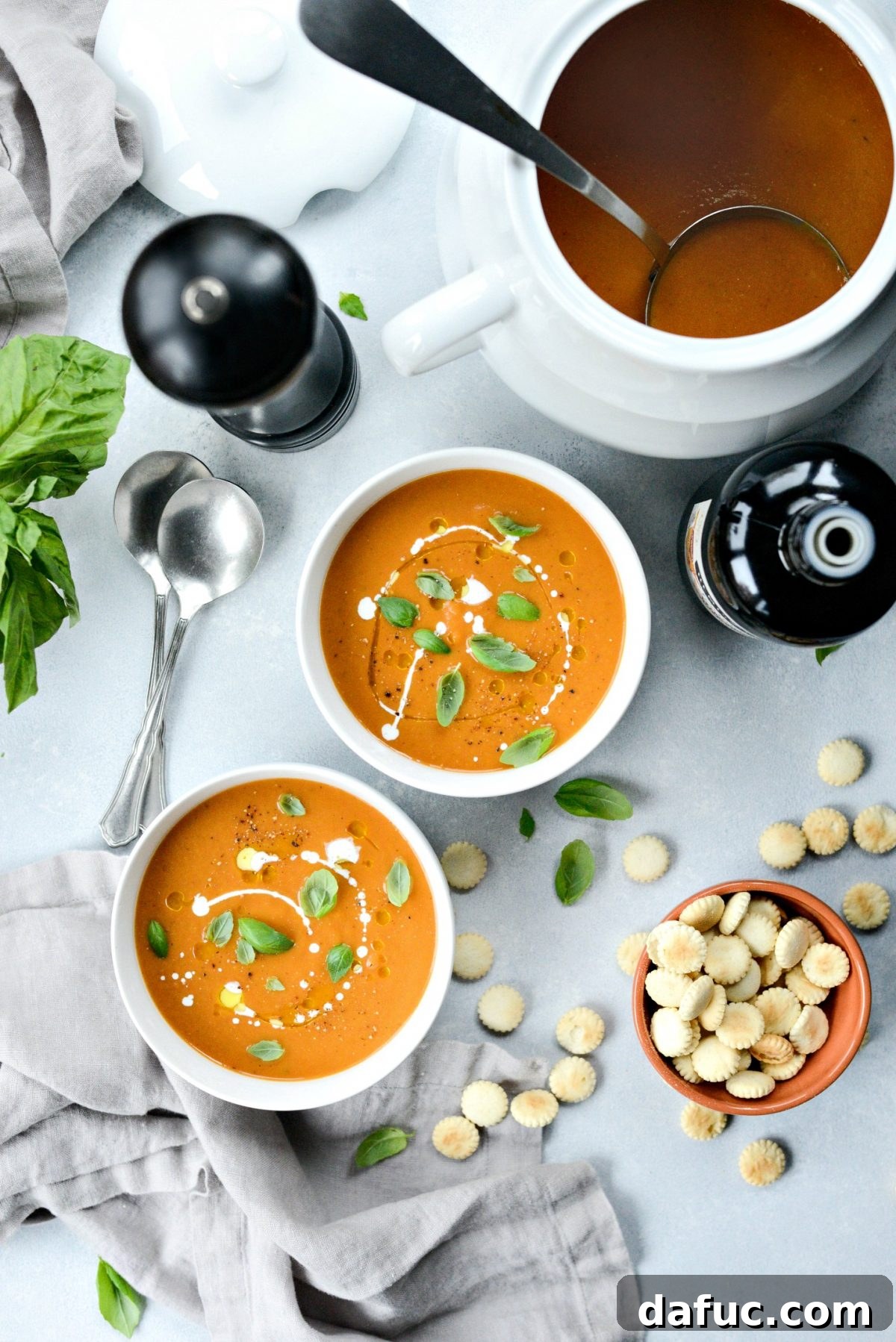 Inviting bowl of Roasted Tomato Pumpkin Soup with a spoon, ready to be enjoyed, depicting cozy comfort