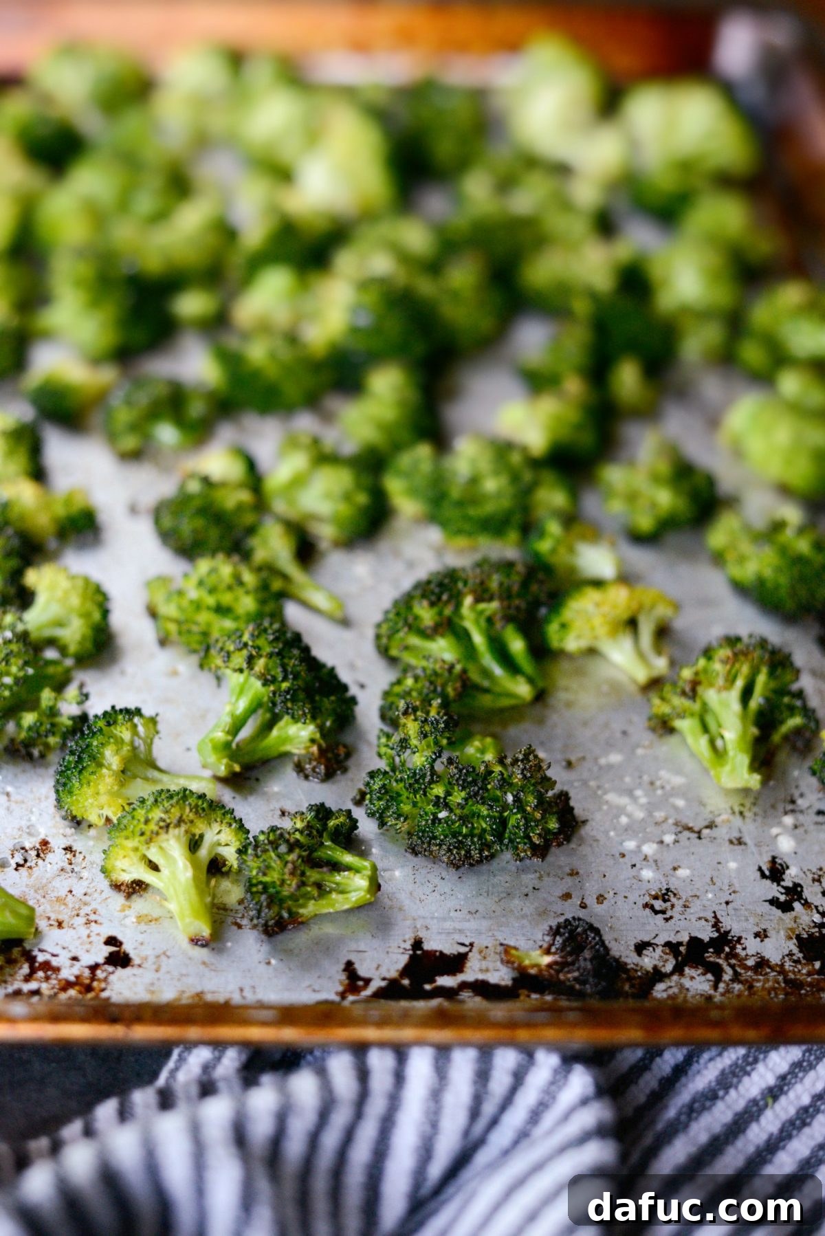 Perfectly roasted broccoli florets with crispy tops and caramelized edges, fresh out of the oven.