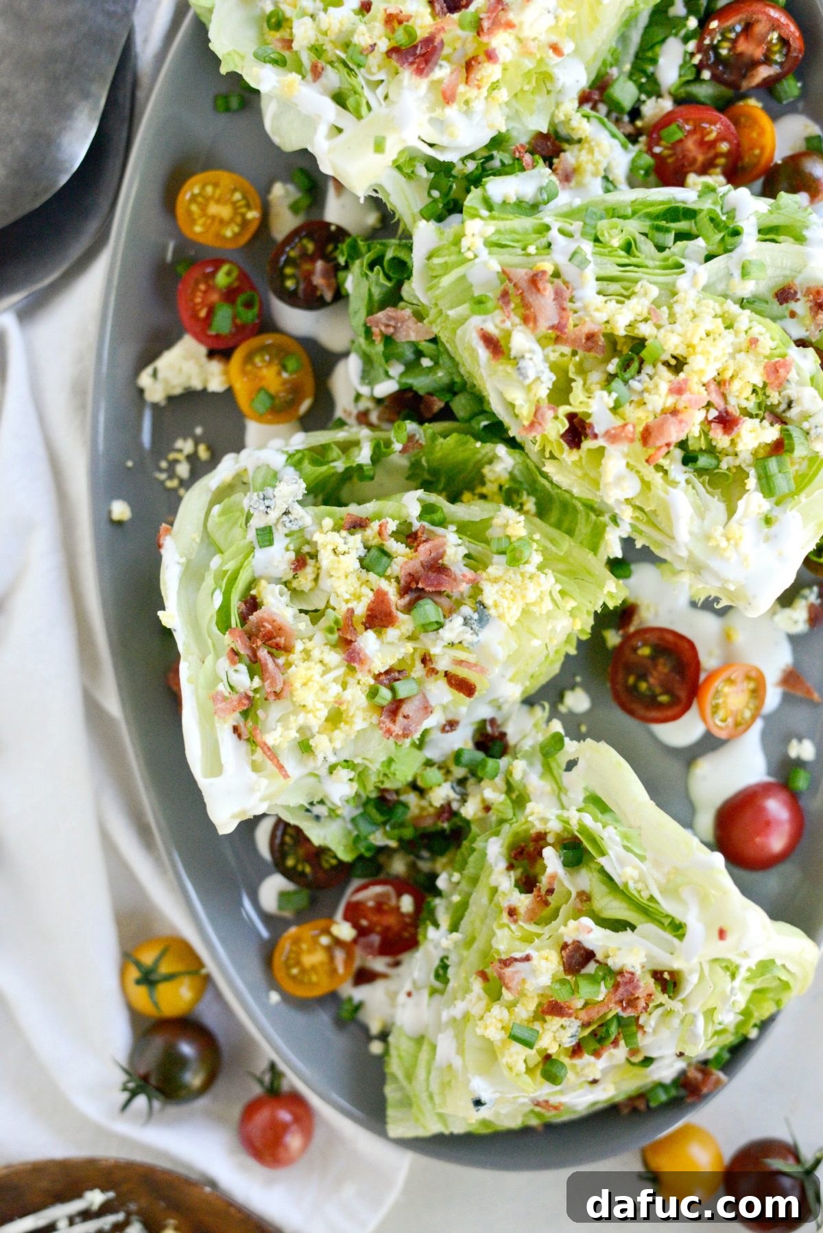 Our Signature Loaded Wedge, Drenched in Peppercorn Buttermilk 11 Another enticing view of the Loaded Wedge Salad with Black Pepper Buttermilk Dressing, beautifully presented for serving.