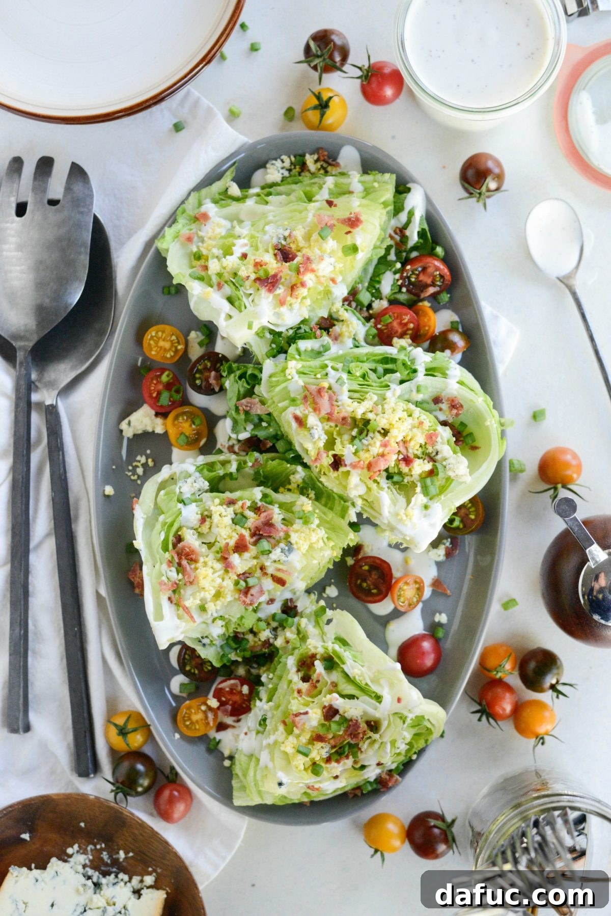 Our Signature Loaded Wedge, Drenched in Peppercorn Buttermilk 3 Close-up shot of the Loaded Wedge Salad, highlighting the creamy black pepper buttermilk dressing, bacon bits, and vibrant toppings.