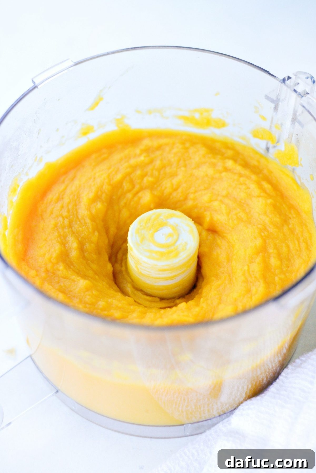 Butternut squash purée being processed in a food processor until perfectly smooth.