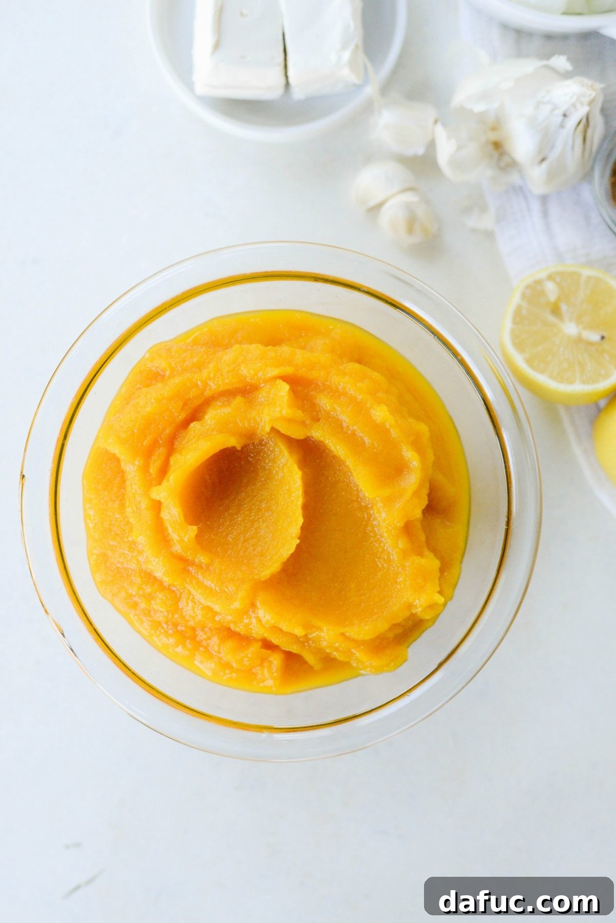 A batch of homemade butternut squash puree stored in a freezer-safe container, ready for future use.