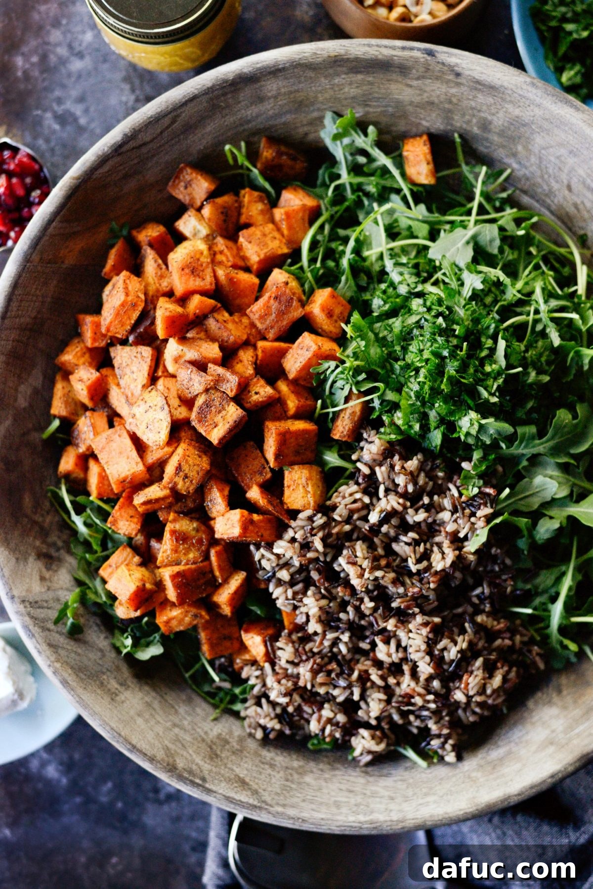 Tossing sweet potatoes, wild rice, arugula, and herbs for the salad