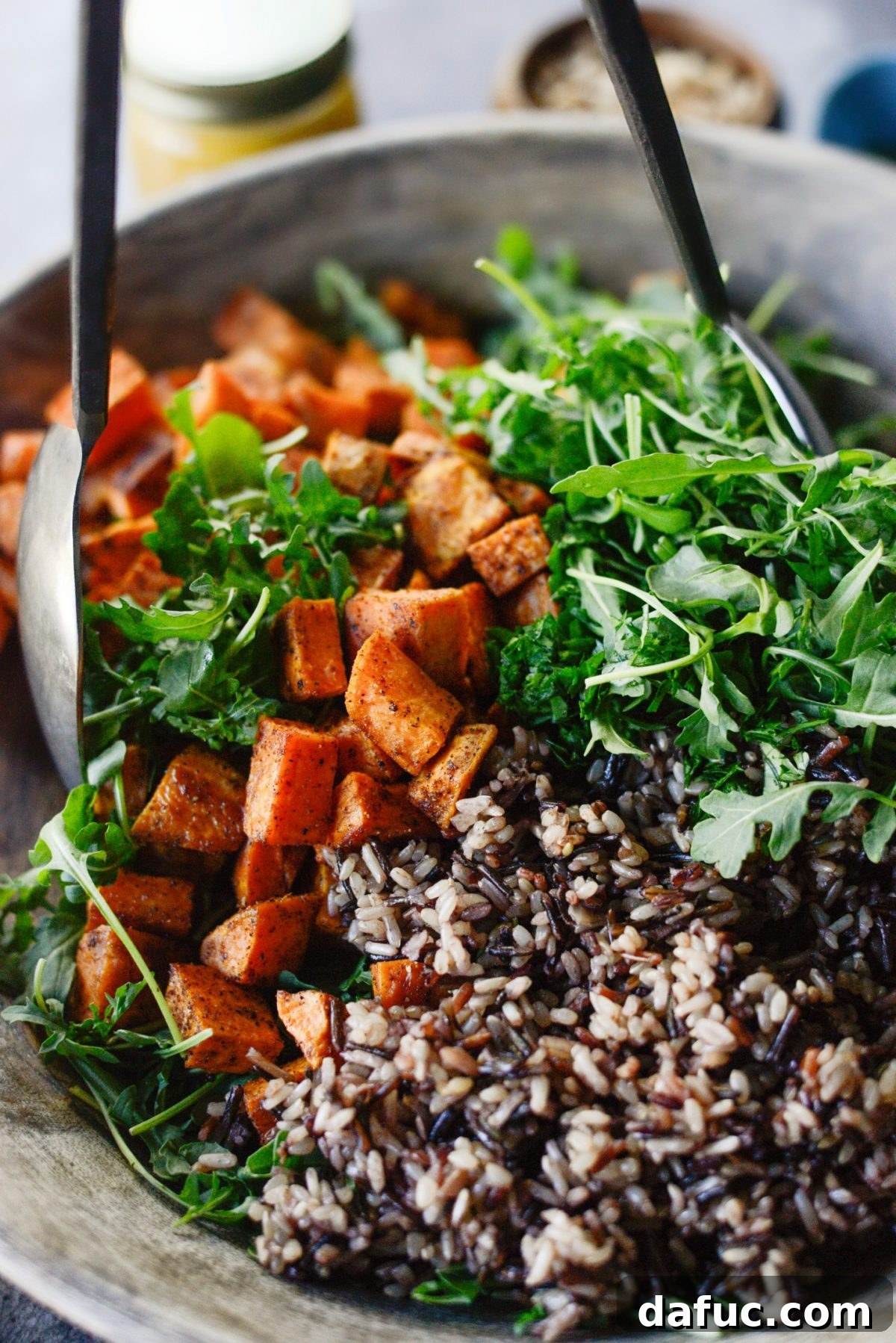 Gently tossing the salad ingredients