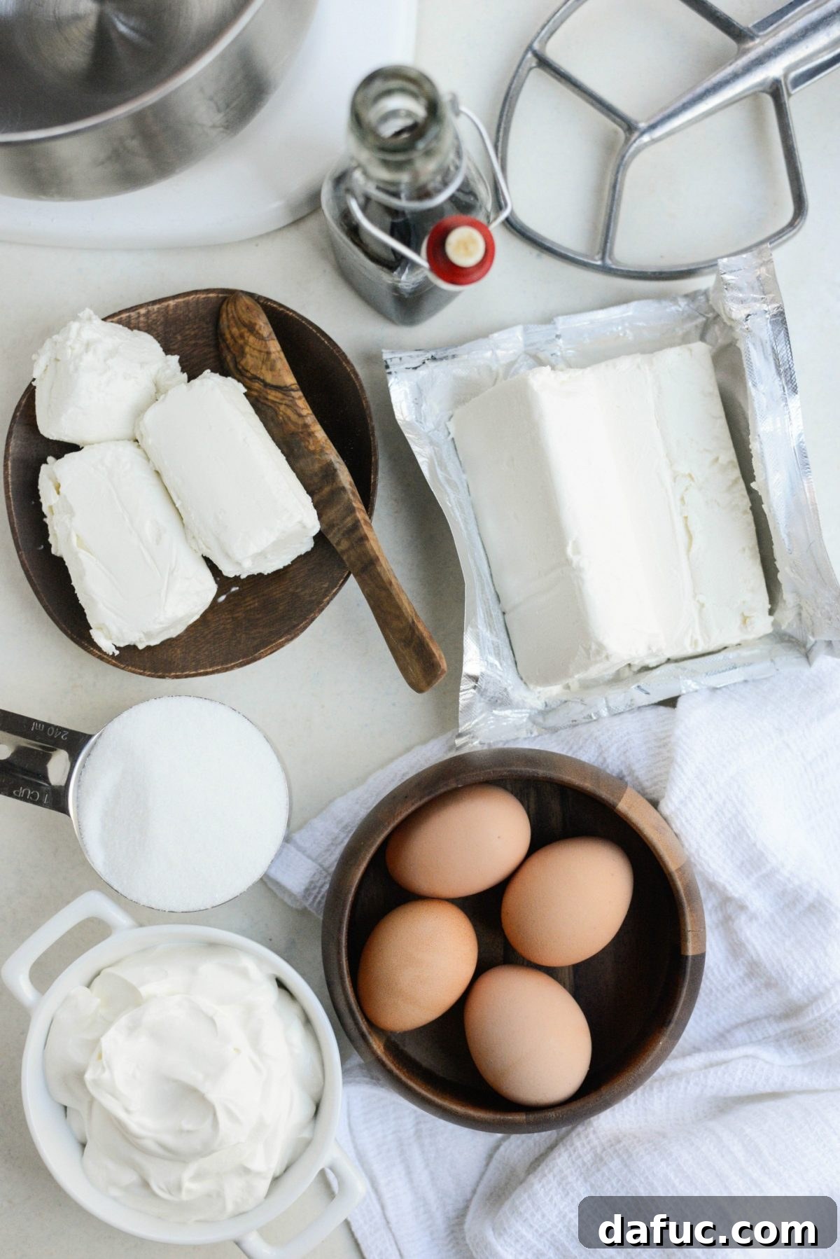 Tangy Goat Cheese Cheesecake with Tahini-Kissed Shortbread Base 7 All the essential ingredients for a smooth and creamy Goat Cheese Cheesecake laid out on a countertop