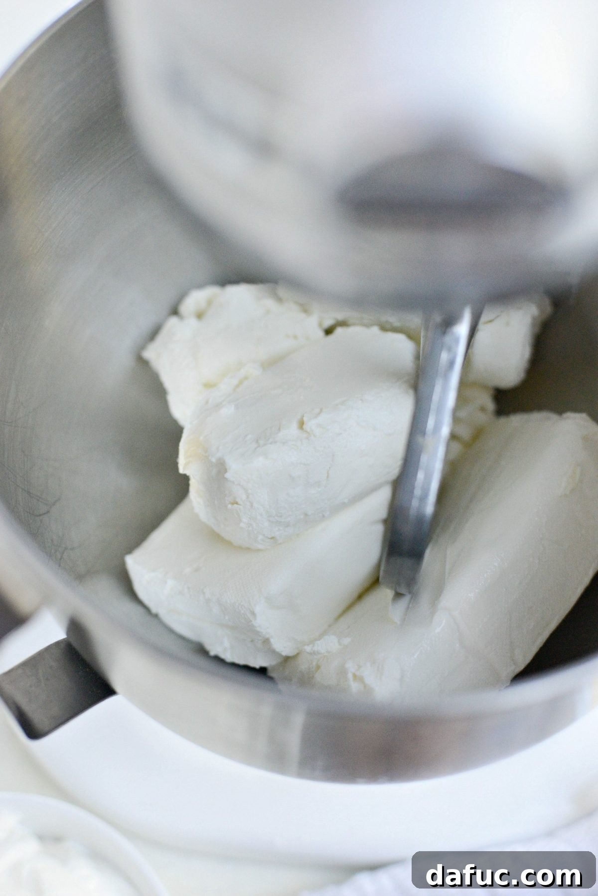 Tangy Goat Cheese Cheesecake with Tahini-Kissed Shortbread Base 8 Softened cream cheese and goat cheese placed in the bowl of a stand mixer, ready for blending