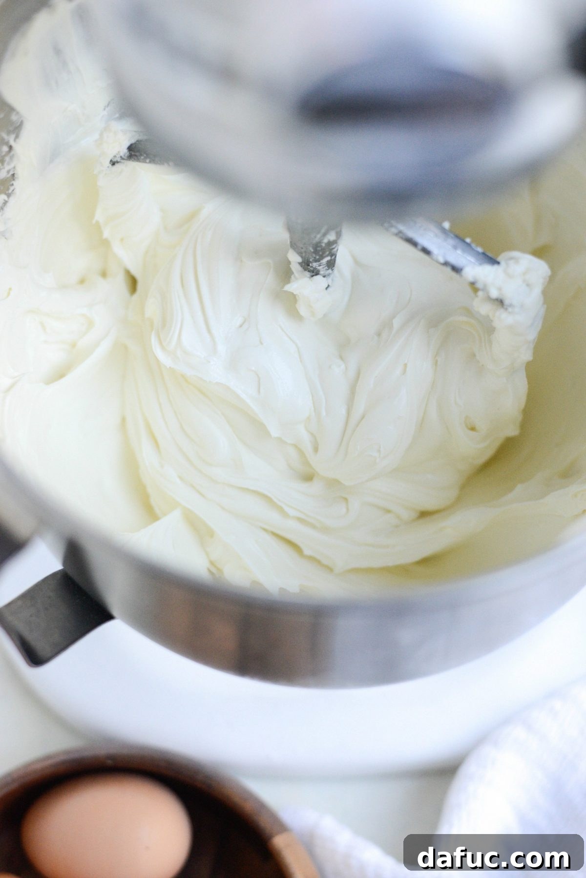 Tangy Goat Cheese Cheesecake with Tahini-Kissed Shortbread Base 10 Sour cream being added to the creamy mixture of cream cheese and goat cheese in the stand mixer