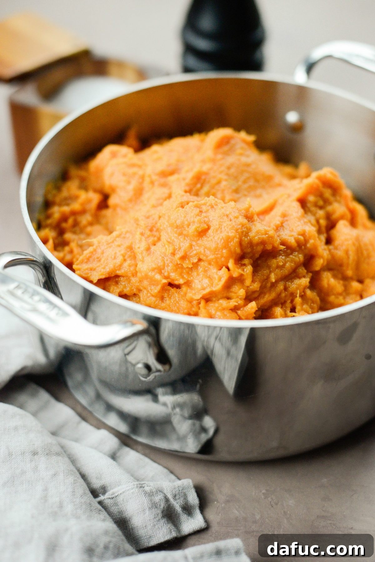 Silky Maple Sweet Potato Mash 12 Transferring the sweet potato mash to a pot to keep warm before serving