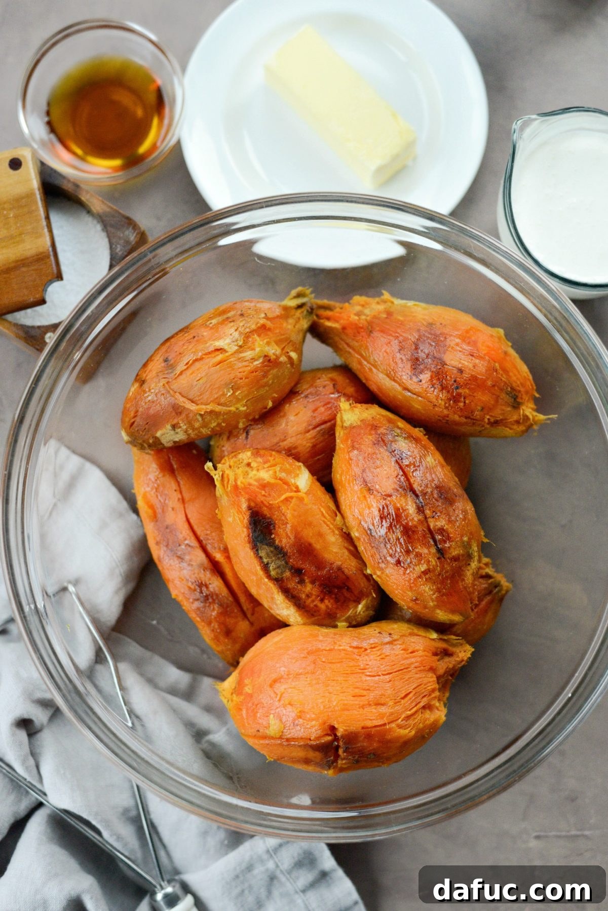 Silky Maple Sweet Potato Mash 6 Scooping roasted sweet potato flesh into a large mixing bowl